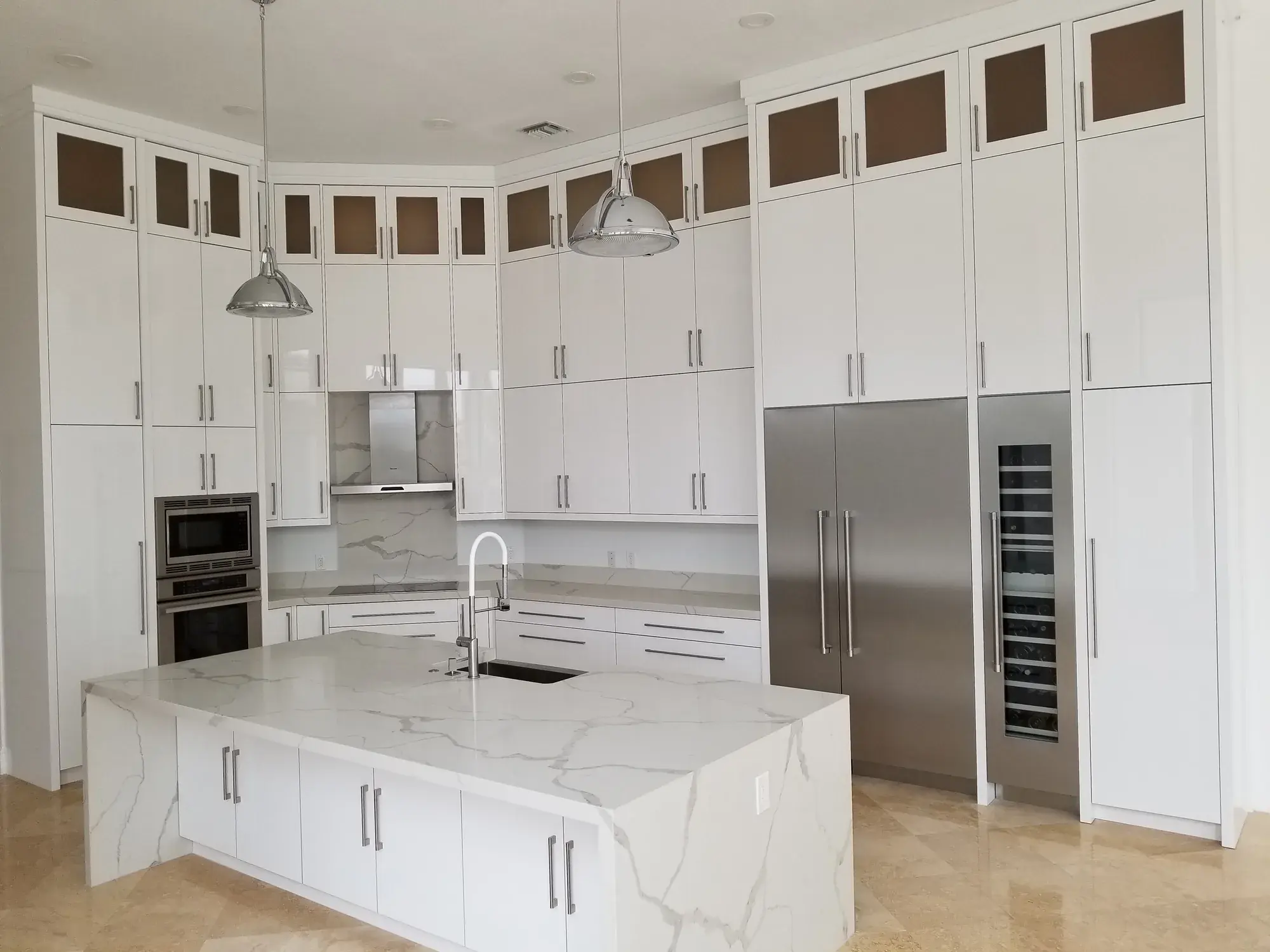 Renovated kitchen with marble waterfall island and floor-to-ceiling cabinetry