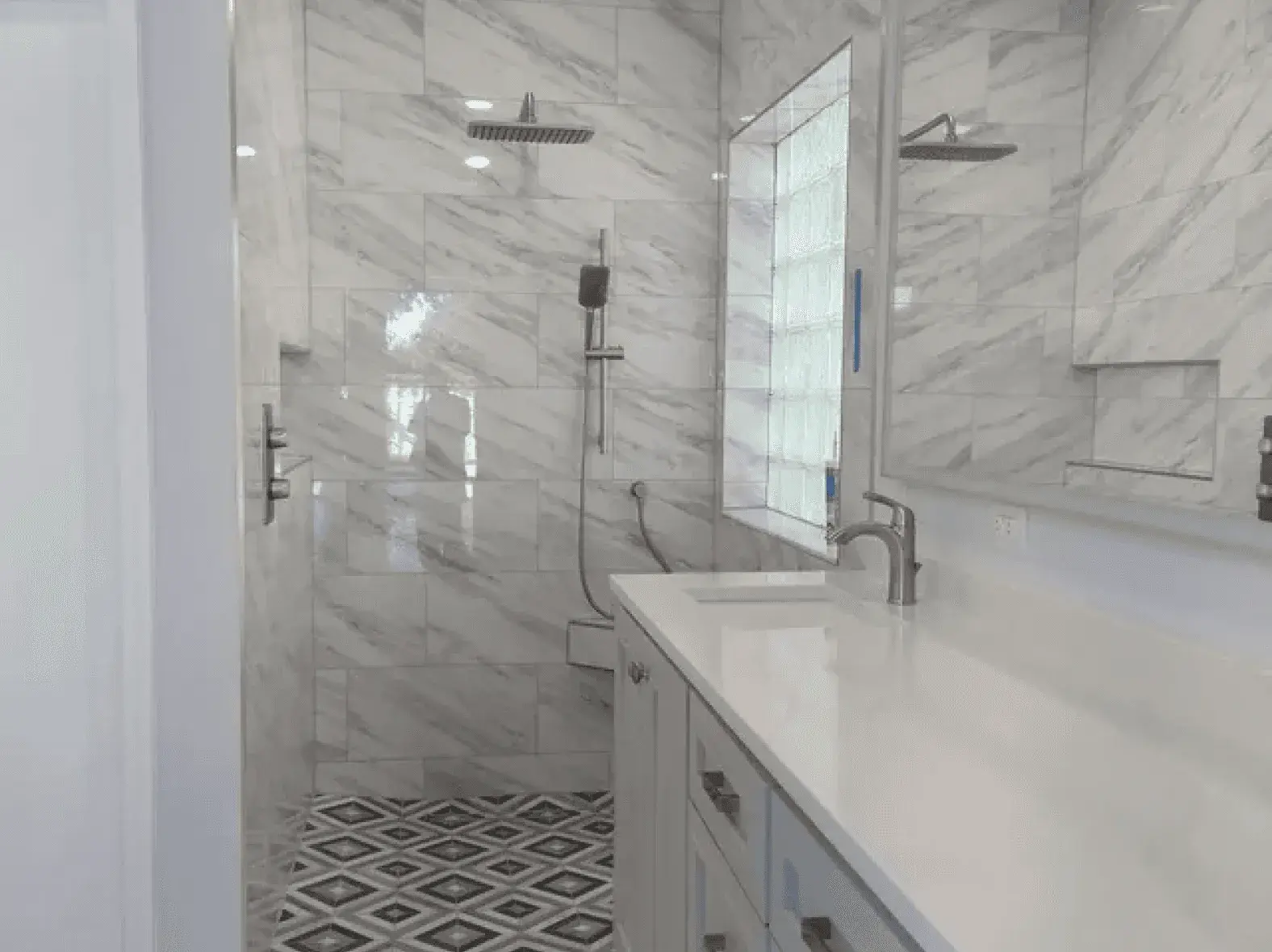 Marble tile walk-in shower with glass enclosure